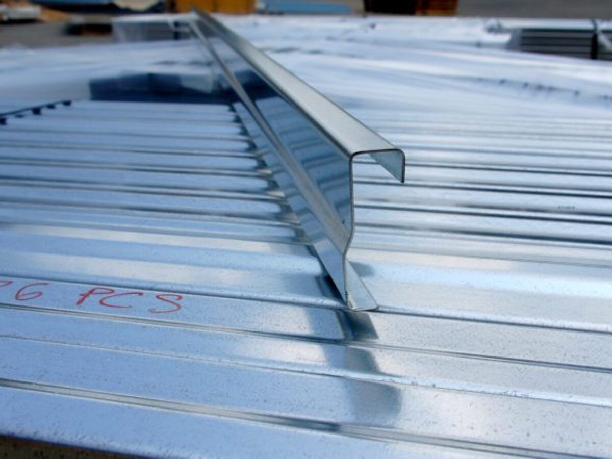 Formed hat channel on a stack of metal panels