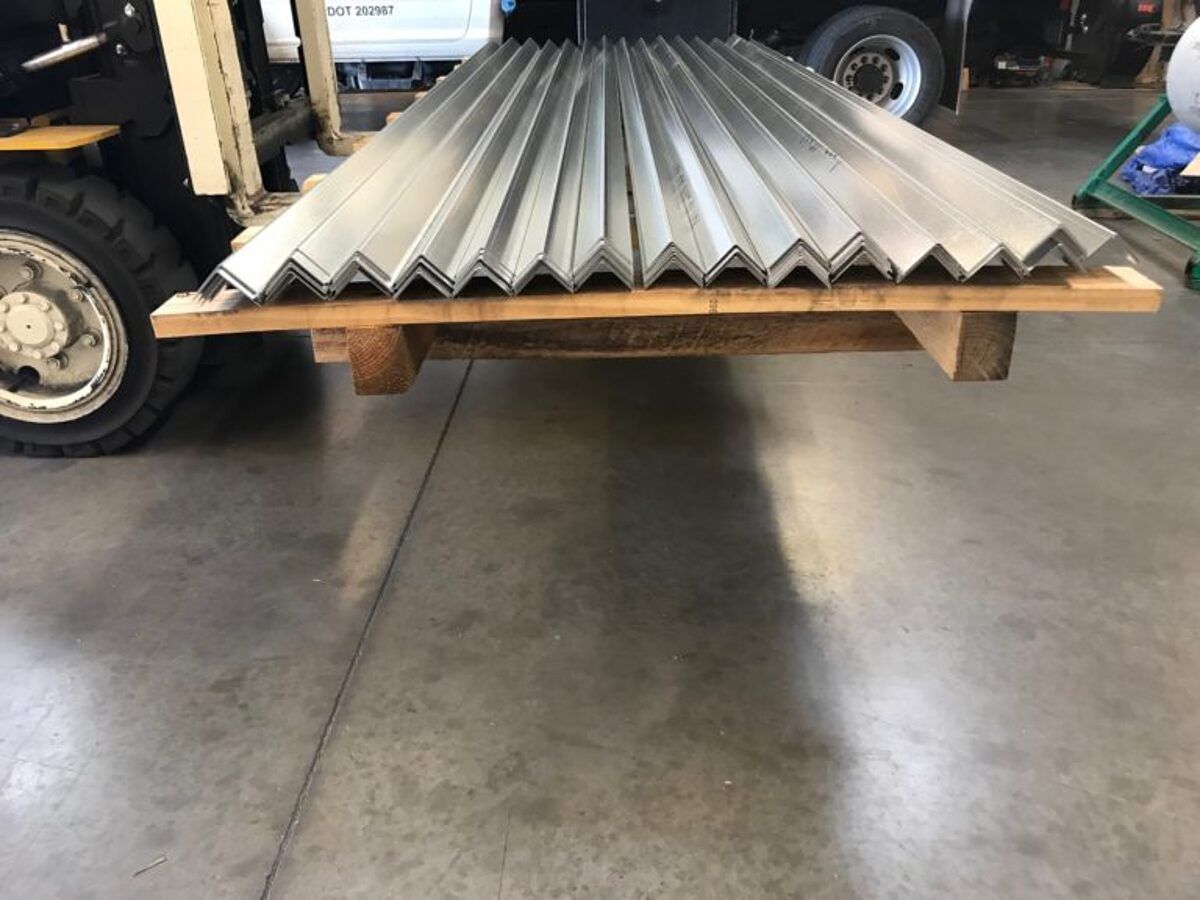 Forklift carrying a bundle of formed profiles in the shop