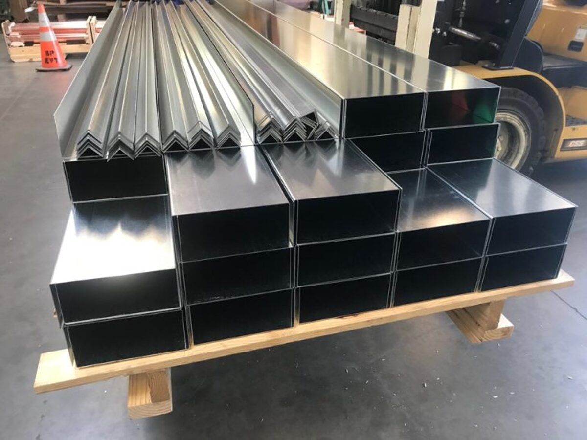 Stacks of formed box and angle profiles staged for shipping