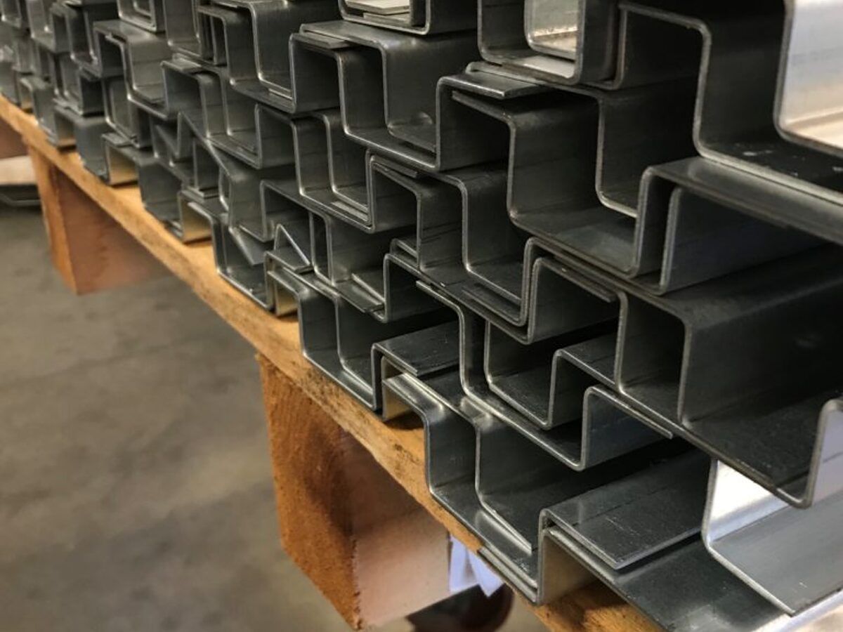 Rows of formed zee and hat channels on a workbench
